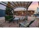 Outdoor living with a stone patio, covered pergola, and comfortable seating at 11398 W Ford Pl, Lakewood, CO 80226