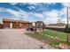 Large backyard with a stone patio, deck, covered pergola, and plenty of space to play at 11398 W Ford Pl, Lakewood, CO 80226