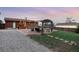 Spacious backyard with a stone patio, deck, pergola, trampoline, and room for outdoor activities at 11398 W Ford Pl, Lakewood, CO 80226
