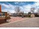 The backyard includes a deck, stone patio, pergola, shed, and trampoline at 11398 W Ford Pl, Lakewood, CO 80226