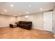 Finished basement with a comfortable brown sectional sofa and recessed lighting at 11398 W Ford Pl, Lakewood, CO 80226