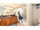 Bathroom featuring a wood vanity, a patterned shower curtain, and decorative accents at 11398 W Ford Pl, Lakewood, CO 80226