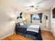 Cozy bedroom with wood floors, ceiling fan, and natural light at 11398 W Ford Pl, Lakewood, CO 80226