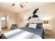 Comfortable bedroom featuring a ceiling fan and black and white decor at 11398 W Ford Pl, Lakewood, CO 80226