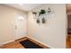 Bright foyer with hardwood floors and a charming shelf with hooks for coats and accessories at 11398 W Ford Pl, Lakewood, CO 80226