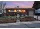 Charming brick home with a cozy front deck and landscaped yard featuring a retaining wall design at 11398 W Ford Pl, Lakewood, CO 80226