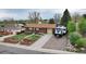 Charming brick home featuring a front yard with garden beds and a driveway with RV parking at 11398 W Ford Pl, Lakewood, CO 80226