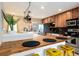 Bright kitchen with butcher block countertop, breakfast bar, and hanging pot rack at 11398 W Ford Pl, Lakewood, CO 80226