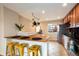 Bright kitchen with tile floor, butcher block countertop, breakfast bar, and hanging pot rack at 11398 W Ford Pl, Lakewood, CO 80226