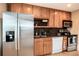 Well-lit kitchen featuring stainless steel appliances and wood cabinetry at 11398 W Ford Pl, Lakewood, CO 80226