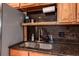 Close up of kitchen sink with wood cabinets and speckled granite countertop at 11398 W Ford Pl, Lakewood, CO 80226