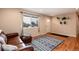 Cozy living room featuring hardwood floors, a large window, and a comfortable leather couch at 11398 W Ford Pl, Lakewood, CO 80226