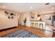 Open living space boasts hardwood floors, a cozy breakfast bar, and inviting decor throughout at 11398 W Ford Pl, Lakewood, CO 80226