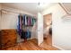 Bright walk-in closet boasts wood floors and ample storage with hanging racks and wood dresser at 11398 W Ford Pl, Lakewood, CO 80226
