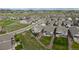 Aerial view of the neighborhood with manicured lawns, and a scenic mountain backdrop at 15604 Xenia Way, Brighton, CO 80602