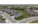 An aerial view showcases a well-planned neighborhood with manicured lawns and tree-lined streets at 15604 Xenia Way, Brighton, CO 80602