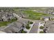 Aerial view of houses near a golf course and pond at 15604 Xenia Way, Brighton, CO 80602
