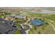 Aerial view of community center, golf course, tennis courts, and parking at 15604 Xenia Way, Brighton, CO 80602