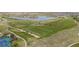 Breathtaking aerial view showcases the golf course community with a lake, lush fairways and well-maintained greens at 15604 Xenia Way, Brighton, CO 80602