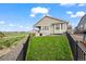 Grassy backyard featuring a well-kept lawn, outdoor grill and covered patio at 15604 Xenia Way, Brighton, CO 80602