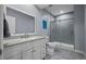 Modern bathroom with a glass-enclosed shower, stylish vanity, and unique flooring at 15604 Xenia Way, Brighton, CO 80602