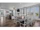 Open-concept layout featuring a dining area with a fireplace and access to the outdoor space at 15604 Xenia Way, Brighton, CO 80602