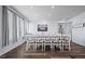 Bright and airy dining room featuring a large table, ample natural light, and stylish decor at 15604 Xenia Way, Brighton, CO 80602