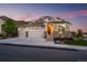 Charming home featuring a three-car garage, stone accents, and a beautifully landscaped front yard at 15604 Xenia Way, Brighton, CO 80602