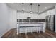 Modern kitchen with stainless steel appliances, granite countertops, and a center island with seating at 15604 Xenia Way, Brighton, CO 80602