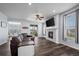 Cozy living room featuring a fireplace, comfortable seating, and seamless access to the patio at 15604 Xenia Way, Brighton, CO 80602