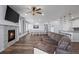 Inviting open-concept living area with modern fireplace, comfortable seating and spacious design at 15604 Xenia Way, Brighton, CO 80602