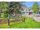 Ornamental bench in a landscaped yard, with homes in the background at 680 S Main St # 19, Breckenridge, CO 80424
