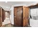 Stackable washer and dryer in a small laundry room with wood doors at 680 S Main St # 19, Breckenridge, CO 80424