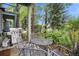 Private patio with a table, chairs and wooded area view at 680 S Main St # 19, Breckenridge, CO 80424
