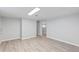 Spacious basement featuring modern vinyl floors and a passageway to another room at 5463 Shoshone St, Denver, CO 80221