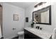 Bright bathroom featuring granite countertop vanity and a shower with neutral tiling at 5463 Shoshone St, Denver, CO 80221