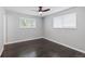 Bright bedroom with wood floors featuring dual sunlit windows and neutral walls at 5463 Shoshone St, Denver, CO 80221