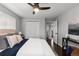 Neutral bedroom featuring a bed, ceiling fan, closet and an open doorway to another room at 5463 Shoshone St, Denver, CO 80221