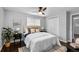 Inviting bedroom featuring a ceiling fan, neutral walls, and a closet with bright natural light at 5463 Shoshone St, Denver, CO 80221