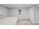 Bedroom featuring a bed, window with bars, wood flooring, and white door at 5463 Shoshone St, Denver, CO 80221