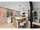 Spacious kitchen featuring a large island with seating, stainless steel appliances, and bright natural light at 5463 Shoshone St, Denver, CO 80221