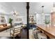 Open-concept kitchen with a butcher block island and a wine fridge connects to a cozy living area at 5463 Shoshone St, Denver, CO 80221