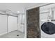 Laundry room featuring barn door, sink and cabinets, and washer and dryer at 5463 Shoshone St, Denver, CO 80221