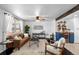 Well-lit living room with a blend of modern decor, hardwood floors, and an open layout at 5463 Shoshone St, Denver, CO 80221