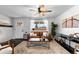 Cozy living room featuring hardwood floors, neutral decor, and large window that fills the space with natural light at 5463 Shoshone St, Denver, CO 80221