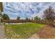 Spacious backyard with patio, gravel, green grass, wood fencing, and nice landscaping at 5975 Hanover St, Denver, CO 80238