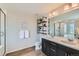 Well-lit bathroom offers double sinks, modern fixtures, and tiled walk-in shower with glass enclosure at 5975 Hanover St, Denver, CO 80238