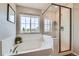 Bathroom features a soaking tub with tile surround, and a frameless glass shower at 5975 Hanover St, Denver, CO 80238
