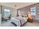 Bedroom features a Queen bed with decorative wallpaper, a pendant light, and two windows at 5975 Hanover St, Denver, CO 80238