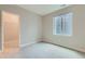 Well-lit bedroom with neutral walls and carpet and a window well with natural light at 5975 Hanover St, Denver, CO 80238